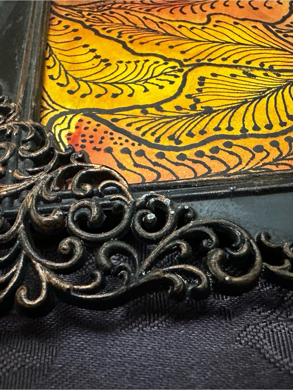 Black Ornate Frame Featuring Yellow-Orange Botanical Artwork